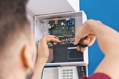 Engineer at alarm panel